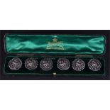 A cased set of six Edwardian silver buttons. Birmingham, 1904 by Henry Matthews. Each detailing an