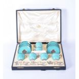 A Royal Worcester porcelain coffee set with black border on turquoise ground, comprising six