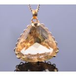 A 22 carat yellow gold mounted citrine pendant set with a large trillion cut citrine of