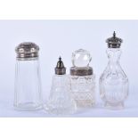 Three silver topped glass salts together with a cut-glass bottle shaped ornament, largest 15 cm. (4)