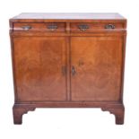 A small mahogany veneered side cabinet small matched drawers with brass handles set above panelled