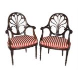 A pair of Hepplewhite style carved mahogany armchairs early 20th century, the framed finely carved