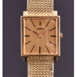 A Corum 18ct gold wristwatch the square gilt engine turned dial with baton hour markers, on an