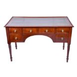 A William IV mahogany writing table the tooled green leather top over a central frieze drawer with