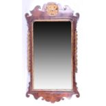 An 18th century Queen Anne style walnut and gilt pier mirror the shaped frame crested with an