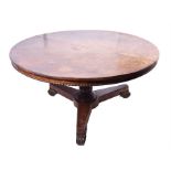 A Regency centre table  veneered throughout in pollard oak. The circular top with a carved beaded