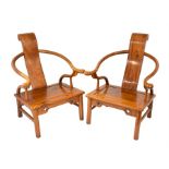A pair of Chinese hardwood horseshoe shaped armchairs with solid seats, solid back splats and