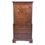 A small Chippendale style mahogany veneered chest on chest the top with blind fret carved frieze,