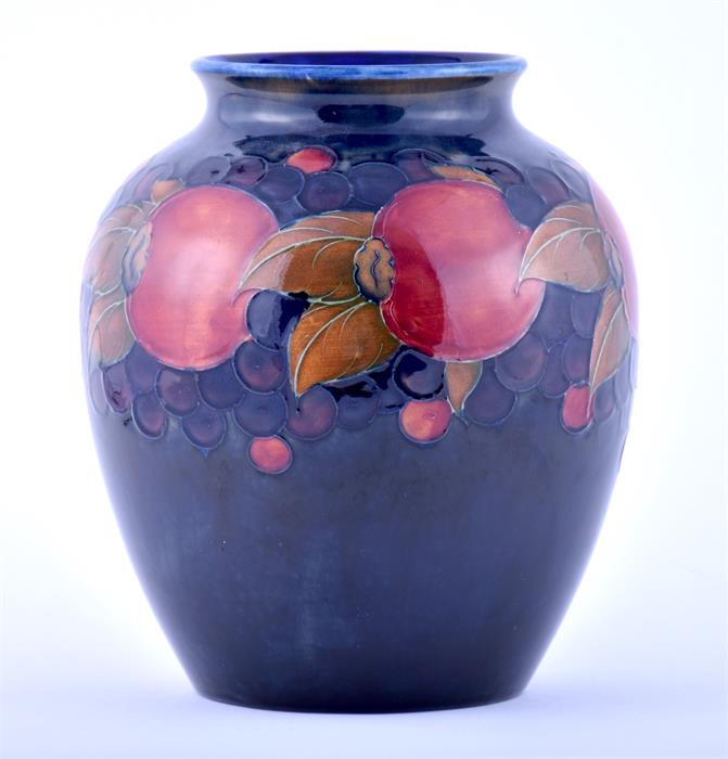 A large William Moorcroft Pomegranate vase of tapering baluster form with cylindrical rim, signature