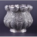 A silver Indian rose bowl decorated with floral vines, with a curved octagonal reticulated rim and