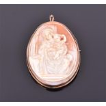 A yellow metal mounted cameo brooch/pendant decorated with an image of the Virgin Mary and Jesus,
