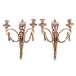 A pair of Louis XVI style classical ormolu twin light wall sconces ornately decorated with