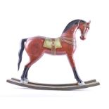 A 20th century Indian small painted rocking horse painted in bright colours, 75cm long.