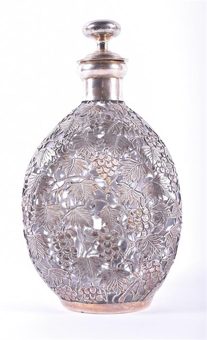 A sterling silver jacketed glass decanter  of triangular form, the pierced silver in the form of