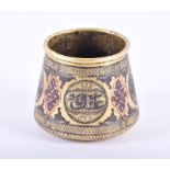 An antique Middle Eastern hand-raised brass vessel embossed and incised, with copper and white metal