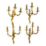 A set of four Louis XVI style ormolu wall sconces the branches formed as scrolls and leaves, with