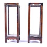 A pair of antique Chinese stained wooden stands  of rectangular form, with studded brass bands and