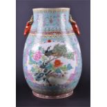 A large good quality Chinese ceramic vase of tapering barrel form, the pale blue ground interspersed