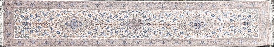 A Persian ivory ground wool Isfahan runner decorated with a central floral roundel and two floral