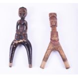 Two African tribal carved wooden catapults the handle of one formed as a fertility symbol, 19.5 cm