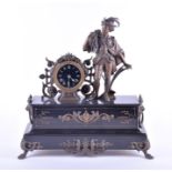 A Victorian figural mantel clock crested by a spelter figure of a farm boy, the clock with black