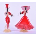 A pair of Murano red and black glass dancing figures one wearing a wide brimmed hat, with long