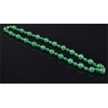 A Chinese green jadeite necklace comprising forty-seven alternating large and small spherical beads,