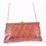 A brown leather and snakeskin handbag of rectangular form with metal clasp and chain, 26cm wide.