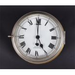 An early 20th century brass cased bulkhead clock with Roman numerals on a white enamel dial, by