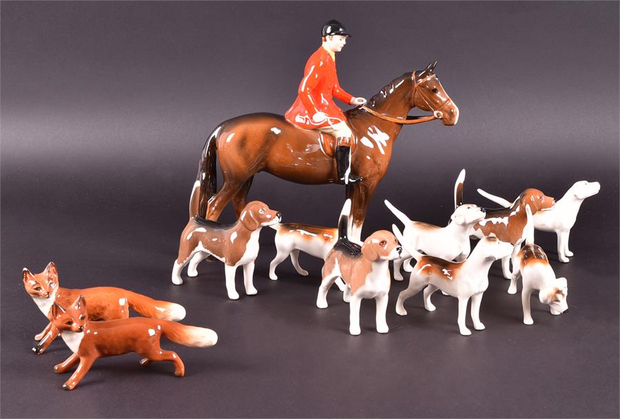 A collection of eleven Beswick hunting figurines comprising: eight hounds, a hunter on horseback and