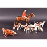 A collection of eleven Beswick hunting figurines comprising: eight hounds, a hunter on horseback and