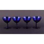 A set of four cobalt blue drinking glasses of circular form with ribbed stems, 9.5 cm high.