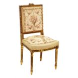 A French needlepoint and gilt wood salon chair with upholstered back and seat, the frame with reeded