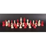 An early 20th century Staunton pattern red and white stained and carved ivory chess set complete,