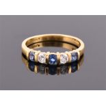 An 18ct yellow gold, diamond and sapphire ring bar set with two round-cut diamonds of