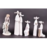 A collection of five Lladro figures to include four nuns and a female golfer, all boxed