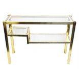 A three tier glass and brass framed shelving display unit with mirrored glass borders, 80 cm high