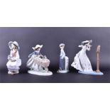A collection of four Lladro figures to include a woman playing a violin and a girl wheeling a barrow