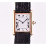 A Cartier 'Tank' 18ct yellow gold wristwatch the signed rectangular dial with black Roman