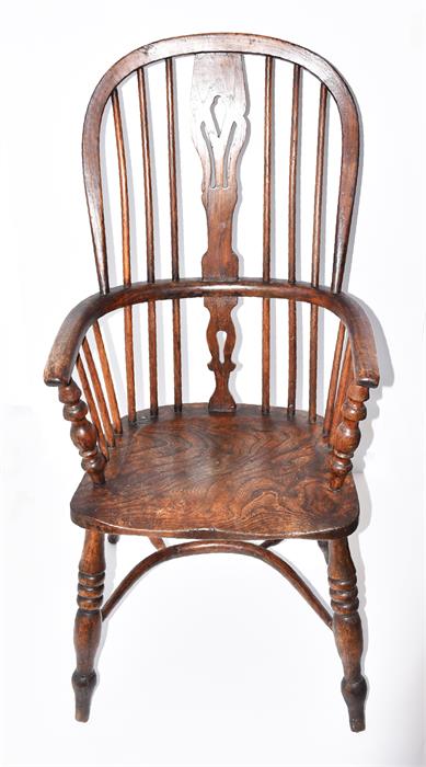 A 19th century elm seated Windsor chair with pierced vase and stick back, and supported on turned