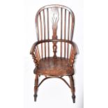 A 19th century elm seated Windsor chair with pierced vase and stick back, and supported on turned