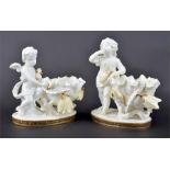 An associated pair of Moore porcelain cream ground dishes one surmounted with a winged cherub, the