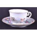 A Naples ceramic cup and associated saucer the cup with highly detailed hand pained and raised