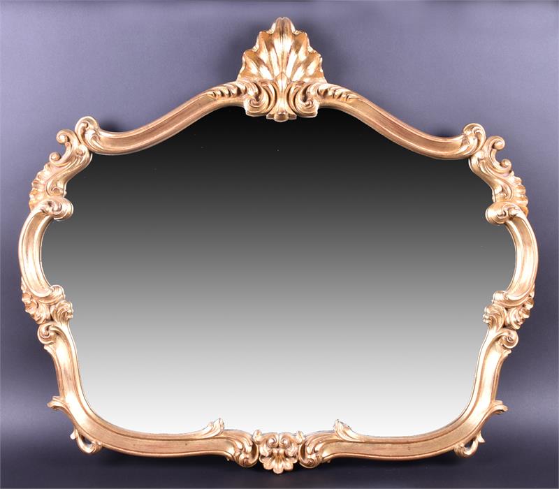 A decorative gilt framed wall mirror with shell surmount and ornate scrolled frame, 82cm wide,