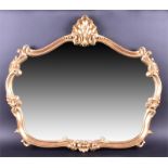 A decorative gilt framed wall mirror with shell surmount and ornate scrolled frame, 82cm wide,