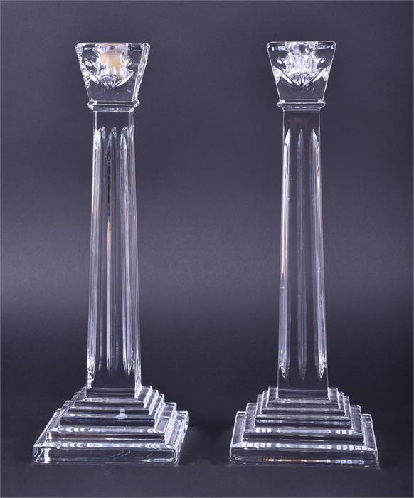 A pair of Waterford Crystal candlesticks with squared tapered stems and stepped bases, marked to