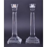 A pair of Waterford Crystal candlesticks with squared tapered stems and stepped bases, marked to