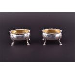 A pair of George III silver salt cellars London 1770, by D & R Hennell, each of oval form on four