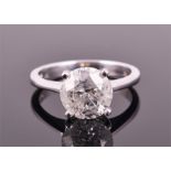 A large solitaire diamond ring claw-set with a round brilliant-cut diamond weighing approximately