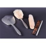 A four-piece silver vanity set Birmingham mid-20th century, comprising of two brushes, a comb and